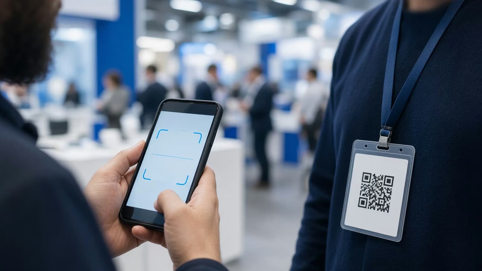 Sales rep scanning a visitor's badge QR code with a phone at a trade show booth