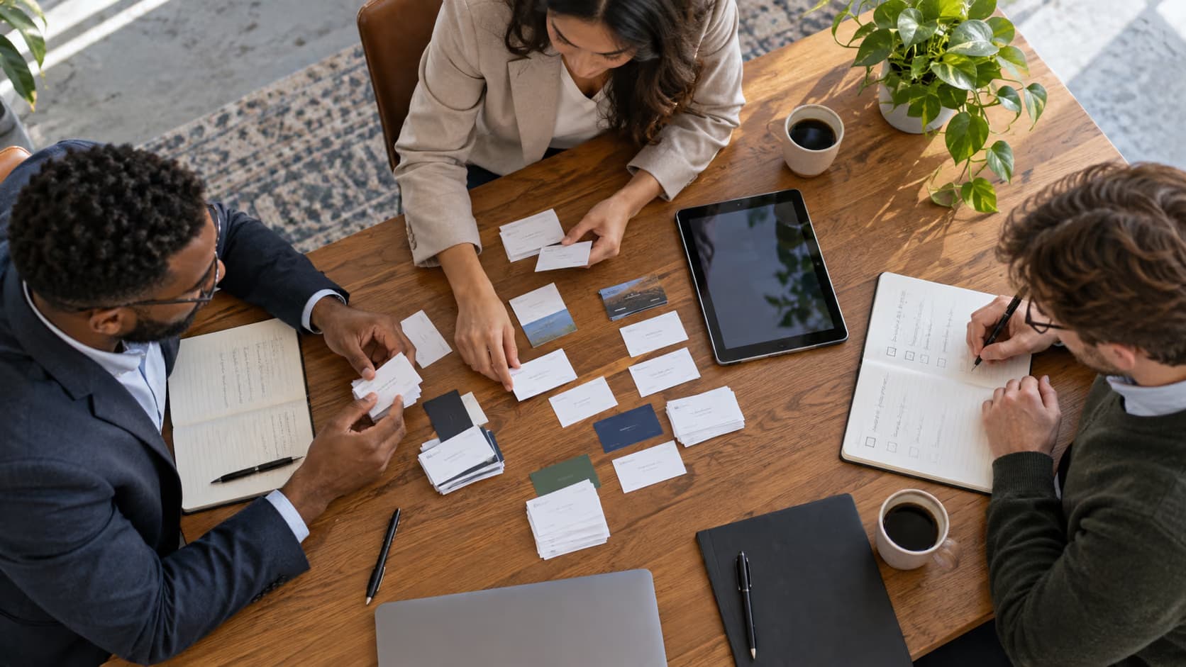 Sales team organizing event contact cards and follow-up handoff notes